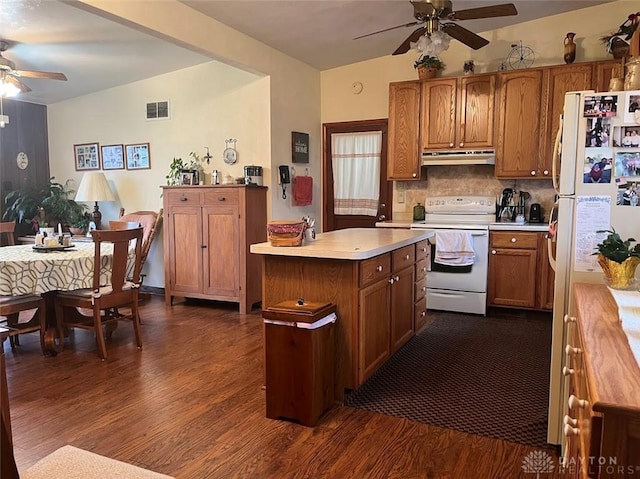 kitchen with lofted ceiling, white appliances, backsplash, dark hardwood / wood-style floors, and ceiling fan