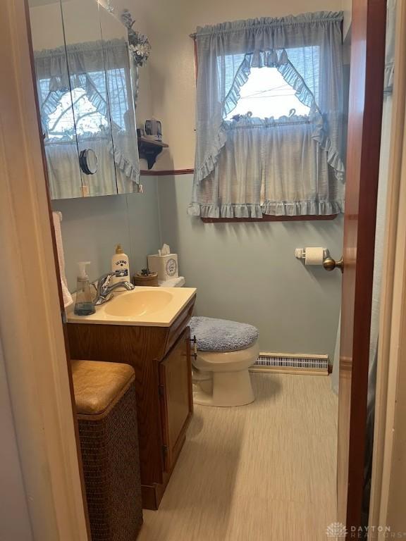 bathroom featuring wood-type flooring, vanity, and toilet