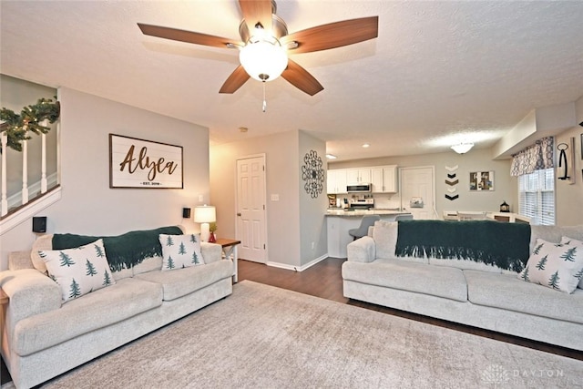 living room featuring a textured ceiling and dark hardwood / wood-style floors