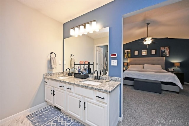 bathroom with ceiling fan, vanity, and lofted ceiling