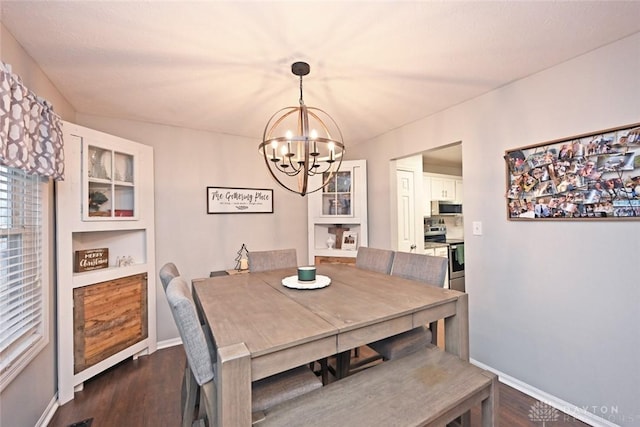 dining area featuring a notable chandelier and dark hardwood / wood-style floors