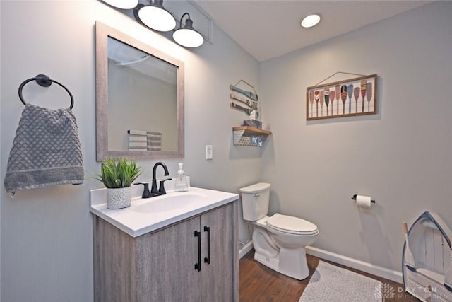 bathroom featuring hardwood / wood-style flooring, vanity, and toilet