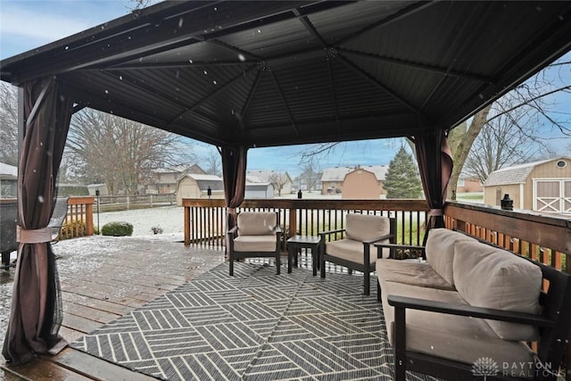 view of patio / terrace featuring a gazebo, an outdoor living space, and a shed