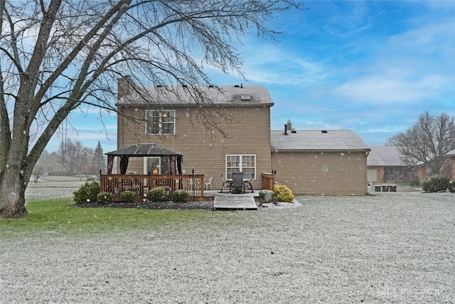 back of property featuring a gazebo, a deck, and a yard