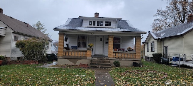 bungalow-style house with a porch and a front yard