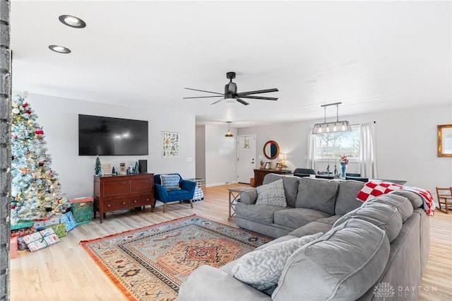 living room featuring wood-type flooring and ceiling fan