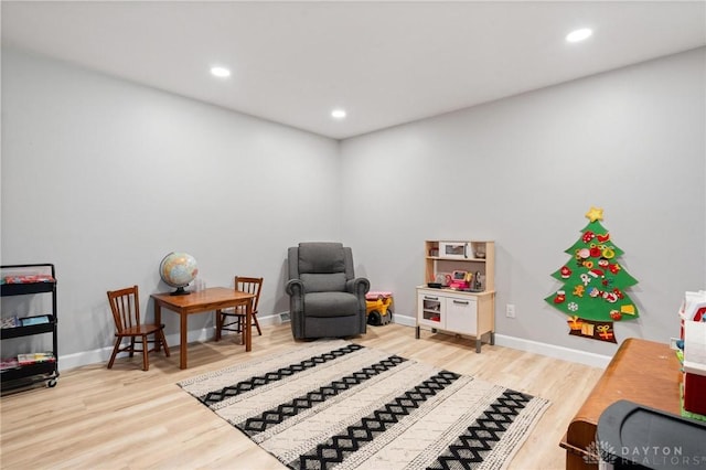 sitting room with wood-type flooring