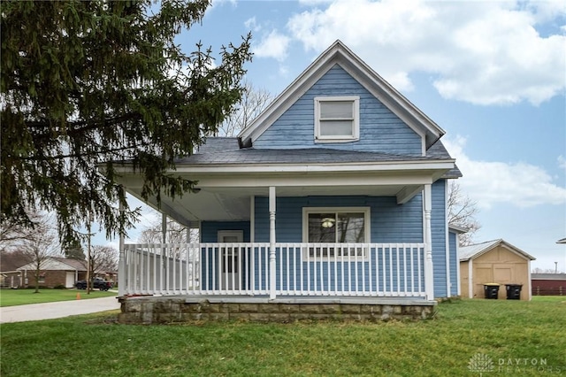 view of front of house with covered porch and a front yard