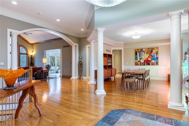 interior space featuring ceiling fan, light wood-type flooring, and ornamental molding