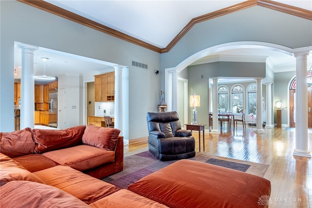 living room featuring lofted ceiling, light hardwood / wood-style floors, and ornamental molding