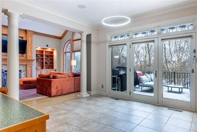 entryway with light tile patterned floors and crown molding