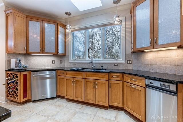 kitchen featuring dishwasher, pendant lighting, a skylight, and sink