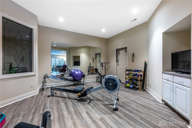 exercise area with light wood-type flooring