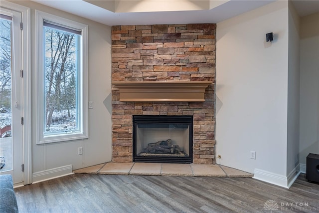 unfurnished living room with a fireplace and wood-type flooring