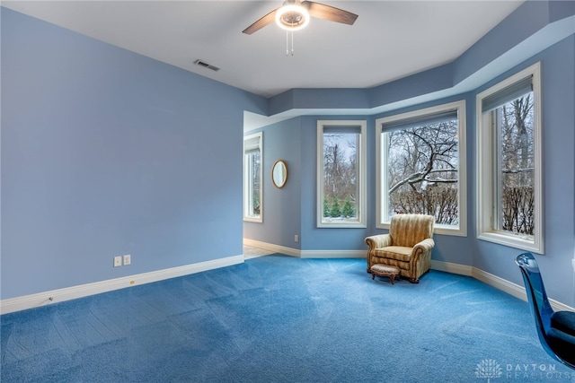 unfurnished room featuring ceiling fan and carpet