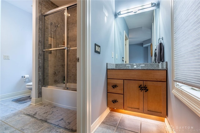 full bathroom featuring tile patterned flooring, vanity, toilet, and combined bath / shower with glass door