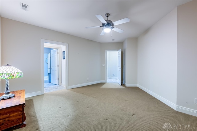 carpeted spare room with ceiling fan