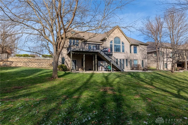 rear view of house featuring a lawn and a deck