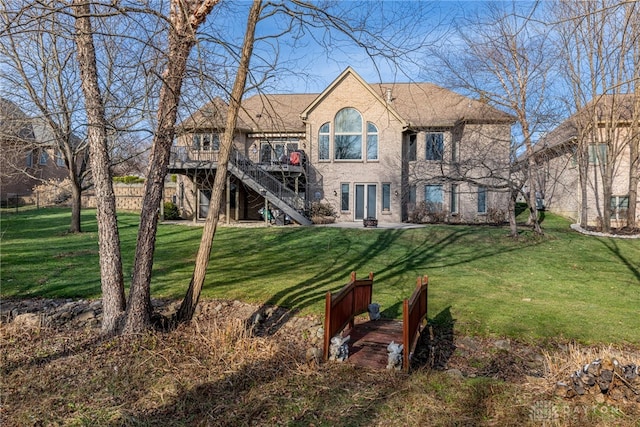 rear view of property with a yard and a wooden deck