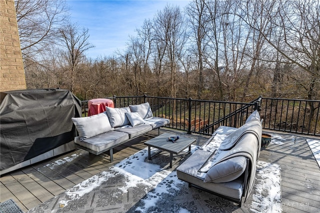 deck featuring an outdoor living space and a grill