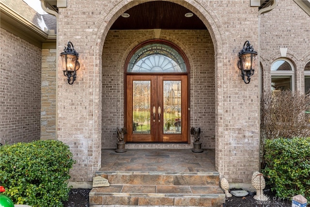 entrance to property with covered porch and french doors