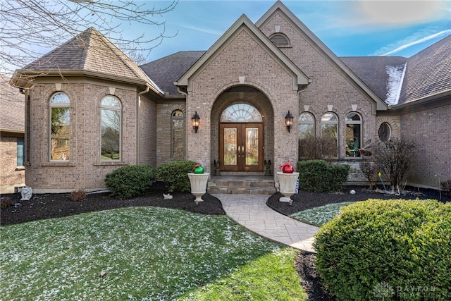 view of front of house with a front lawn and french doors