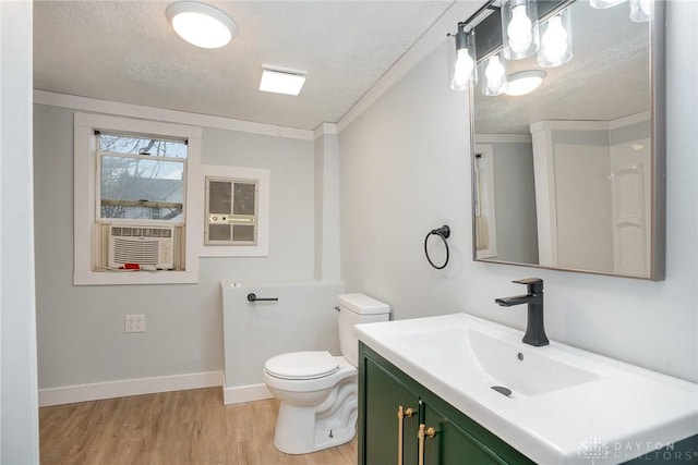 bathroom with crown molding, wood-type flooring, toilet, and a textured ceiling