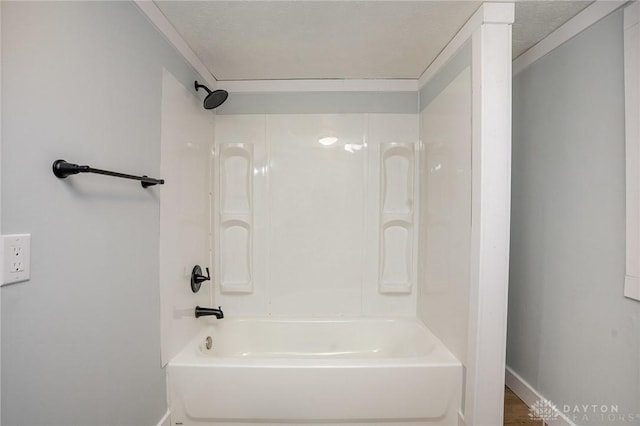 bathroom featuring shower / tub combination and ornamental molding