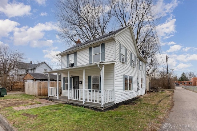 view of front facade with a front yard and a porch