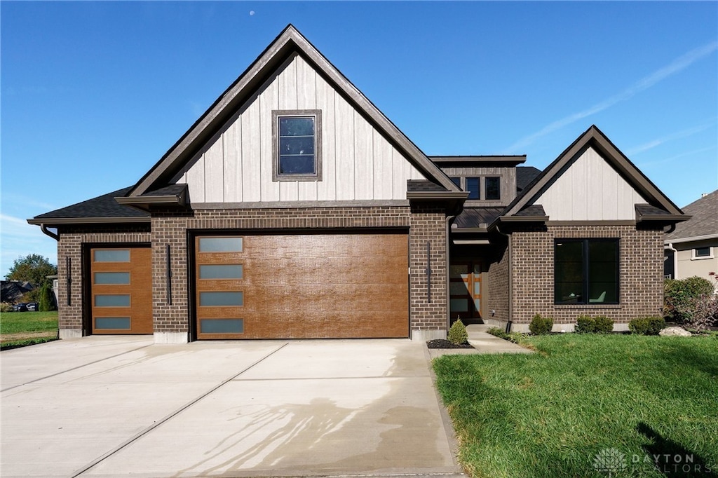 view of front of house with a garage and a front lawn