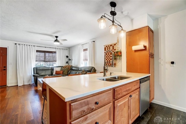 kitchen featuring stainless steel dishwasher, ceiling fan, sink, decorative light fixtures, and dark hardwood / wood-style floors