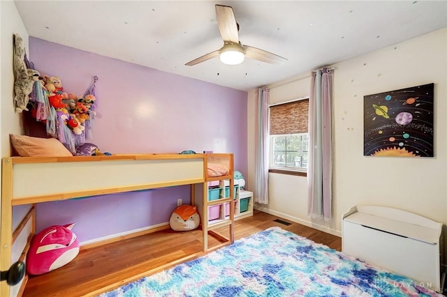 bedroom with ceiling fan and wood-type flooring