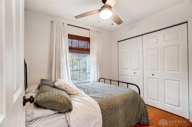 bedroom with ceiling fan, a closet, and wood-type flooring