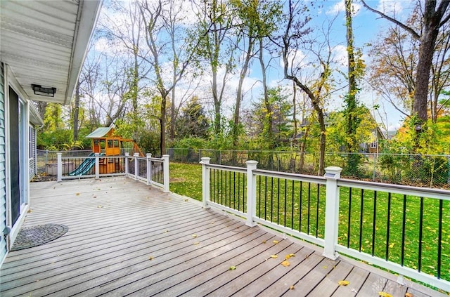 deck featuring a playground and a lawn