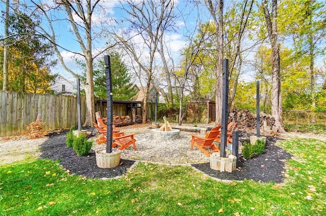 view of yard with a fire pit