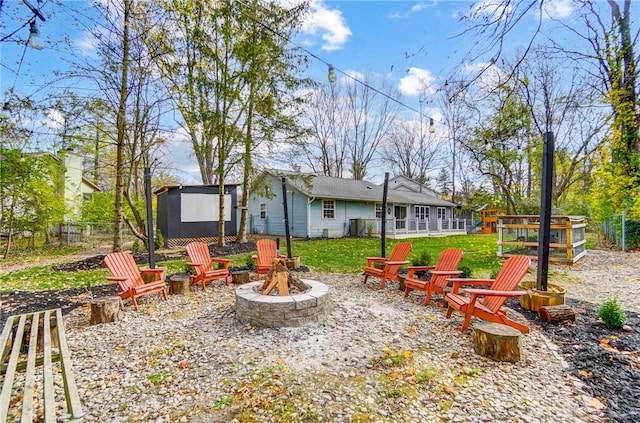 view of yard featuring a fire pit and a storage shed