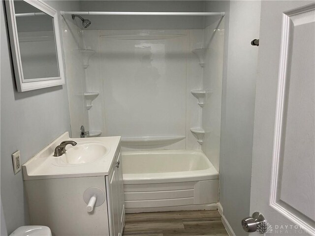 full bathroom featuring vanity, shower / tub combination, toilet, and wood finished floors