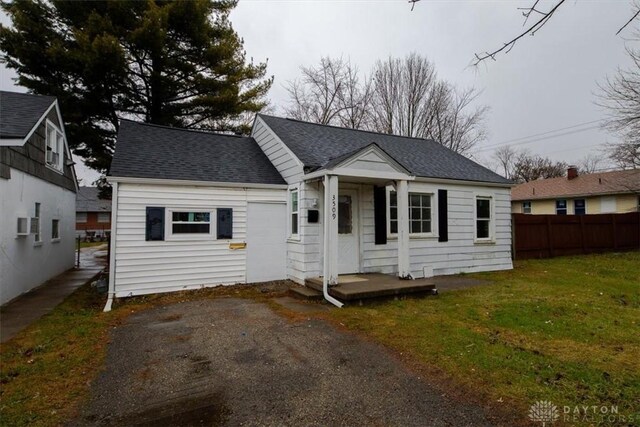 rear view of house with a yard