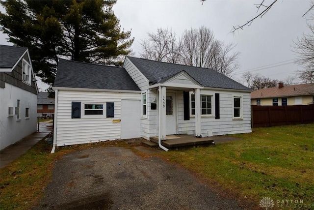 rear view of house featuring a yard