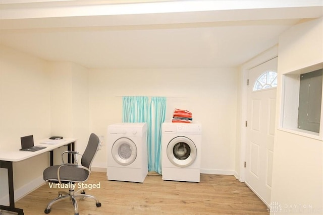 clothes washing area with light wood-type flooring, electric panel, and independent washer and dryer