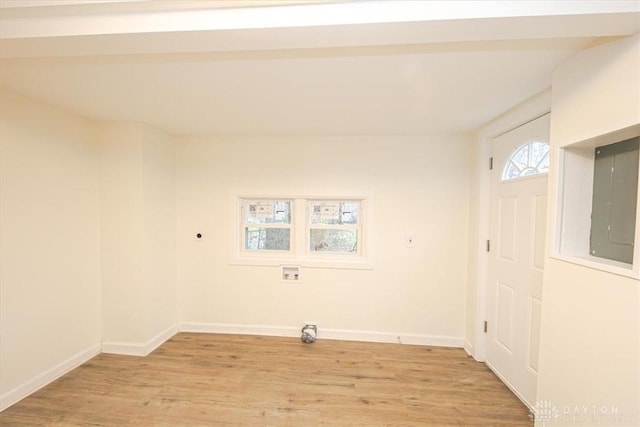 interior space featuring washer hookup, electric panel, light hardwood / wood-style floors, and electric dryer hookup