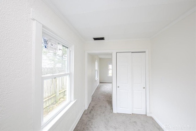 hall with light carpet and ornamental molding