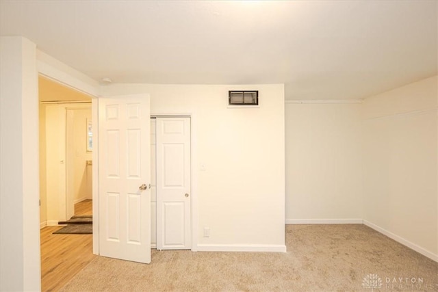 basement featuring light carpet