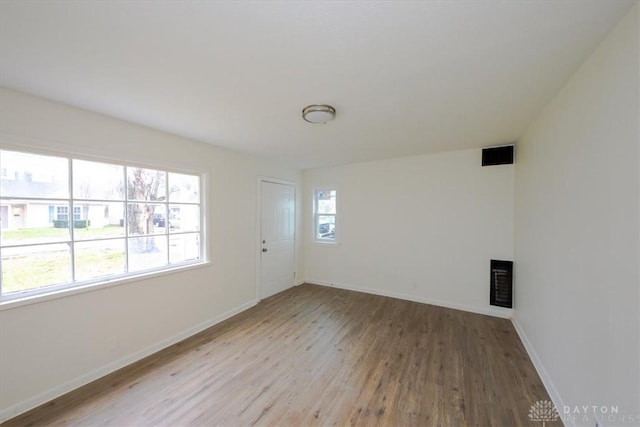 empty room with light hardwood / wood-style flooring