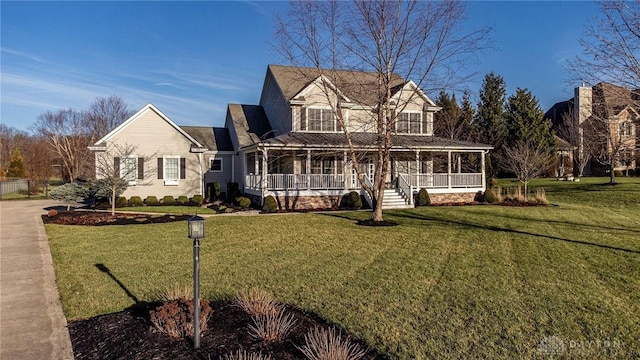 farmhouse featuring a porch and a front lawn