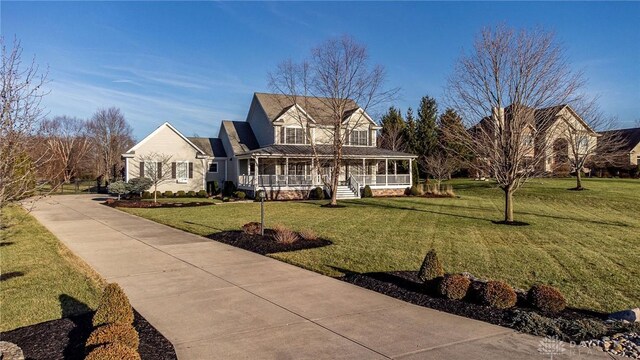 farmhouse-style home featuring a porch and a front lawn