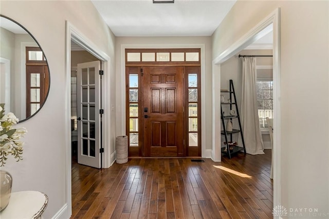 foyer featuring plenty of natural light and dark hardwood / wood-style floors