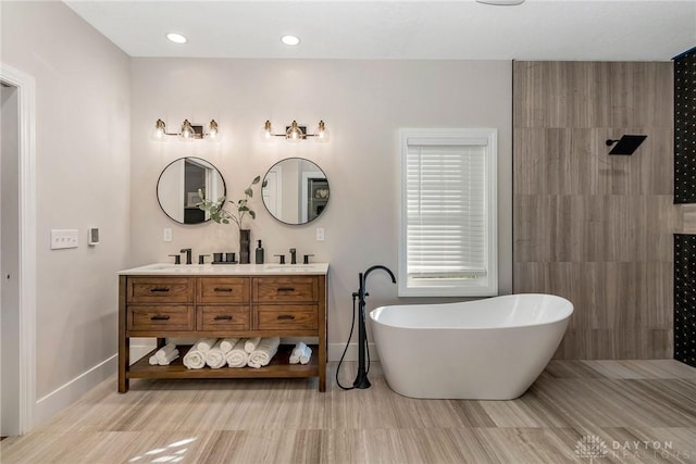 bathroom featuring shower with separate bathtub and vanity