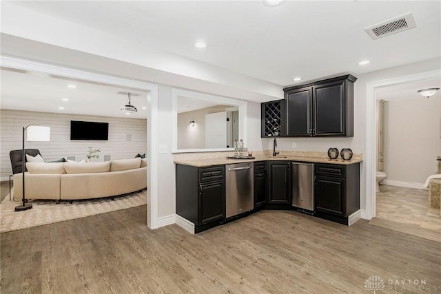 kitchen with dishwasher, light hardwood / wood-style floors, and sink