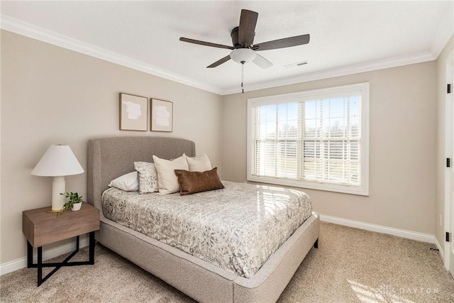 bedroom with light colored carpet, ceiling fan, and crown molding